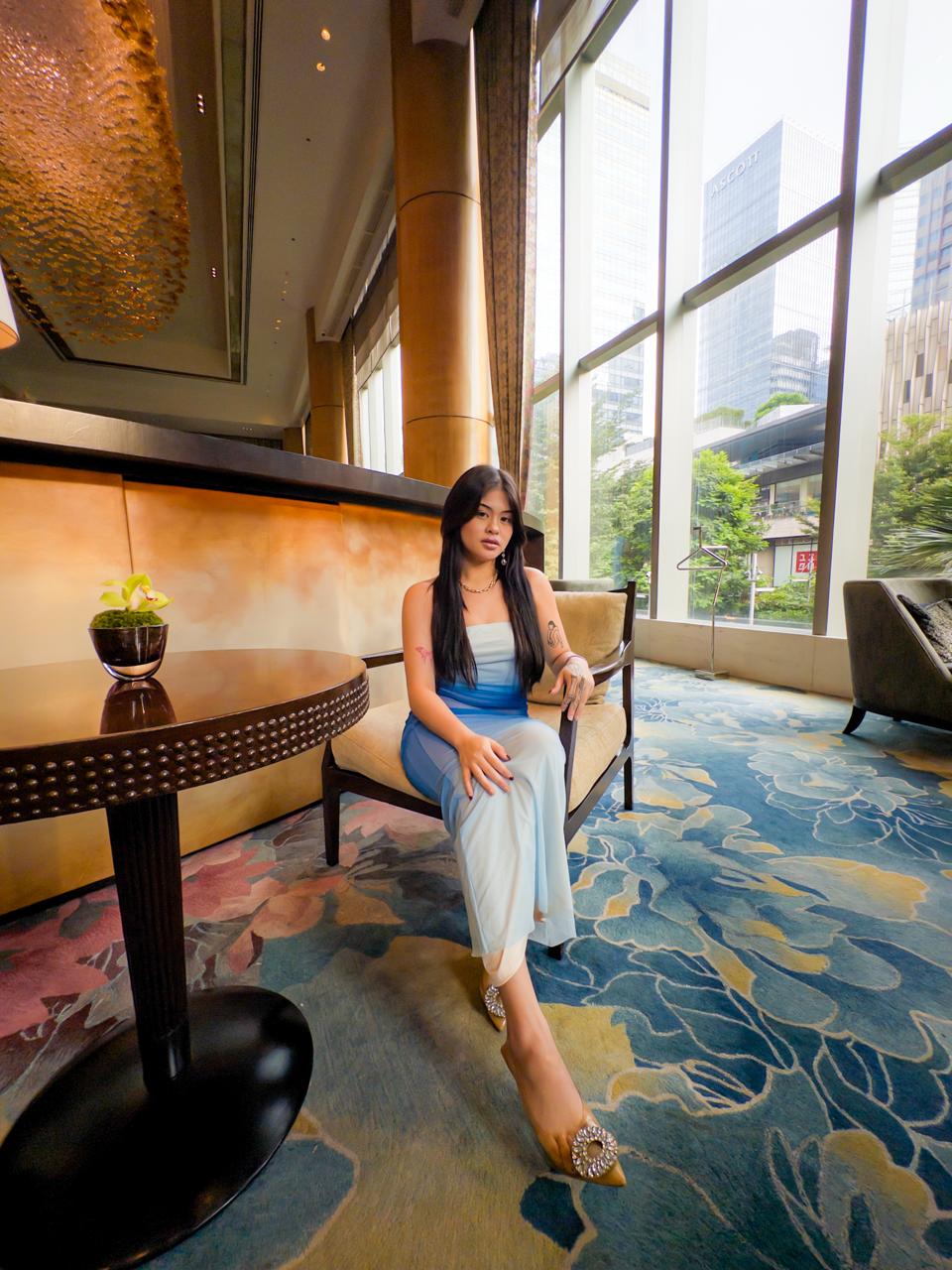 Sienna at Shangri-La The Fort Lounge, full-body portrait in blue dress