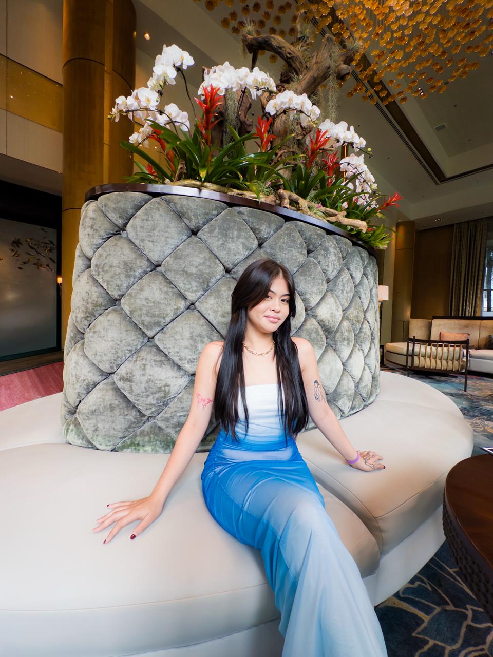 Sienna surrounded by floral decor at Shangri-La The Fort Lounge in BGC