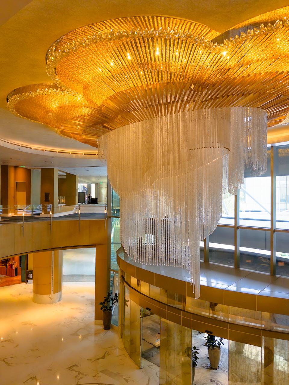 Grand crystal chandelier centerpiece illuminating the Shangri-La The Fort main lobby