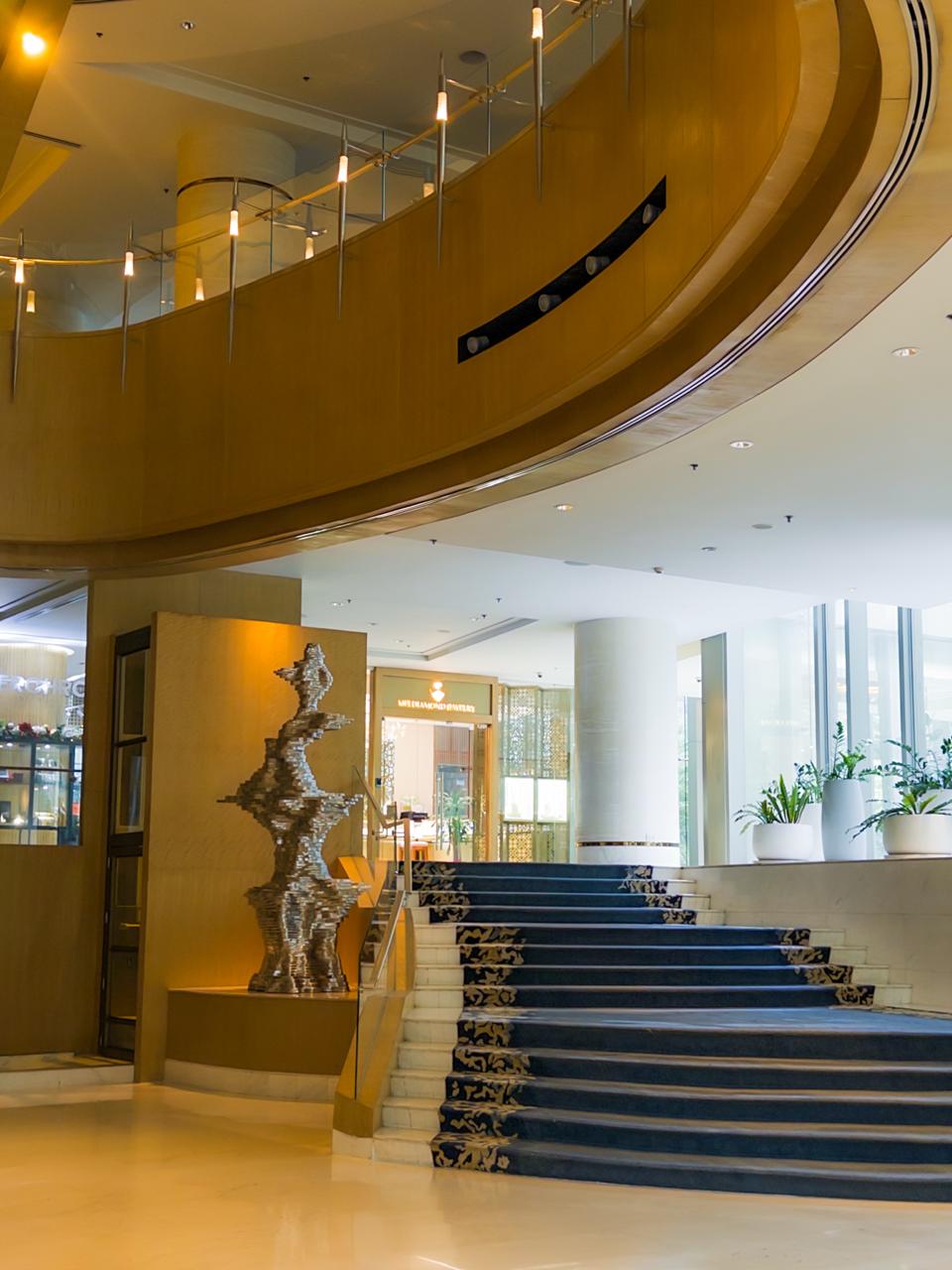 Elegant blue-carpeted staircase in the lobby of Shangri-La The Fort Manila